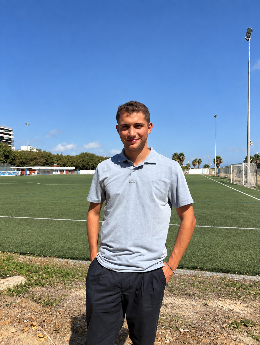 Max Llahuet standing in front of a football pitch