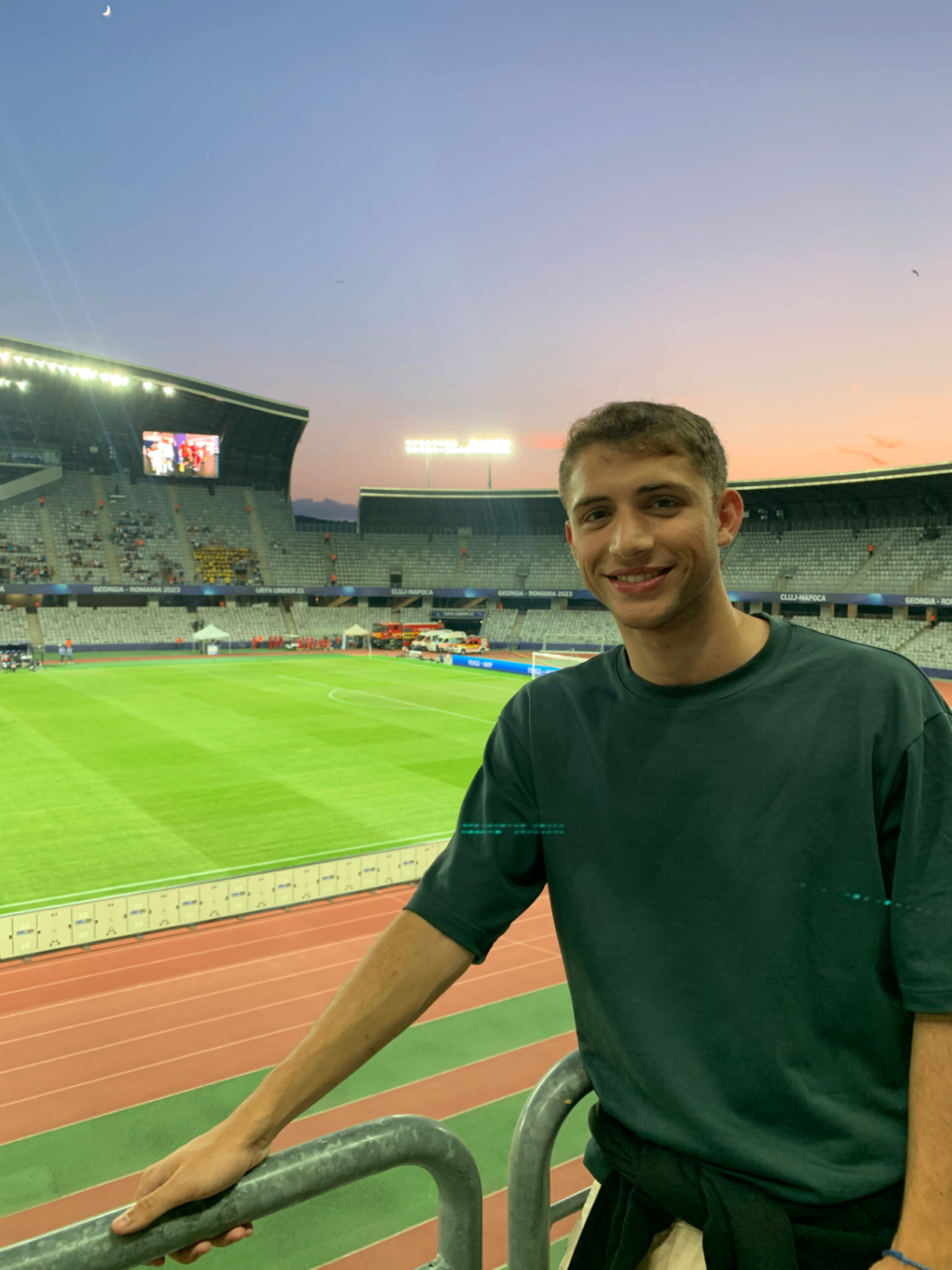 Max Llahuet beside the pitch at a football stadium in Cluj-Napoca